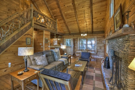 Ridgetop Pointaview- Entry level living room seating with perspective view of the loft and kitchen