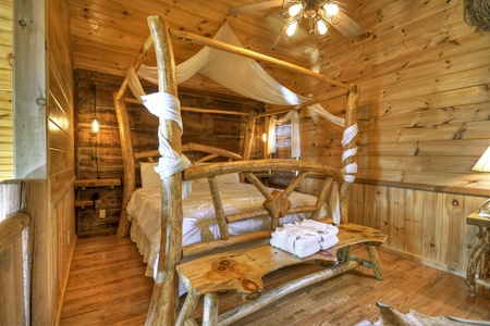Grand Mountain Lodge- Upper level king loft with a rustic bedframe