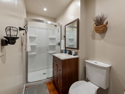 Moonlight Retreat- Entry level guest bathroom with walk in shower, toilet and sink