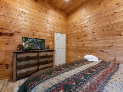 Moonlight Retreat- Entry level guest bedroom with a dresser and TV