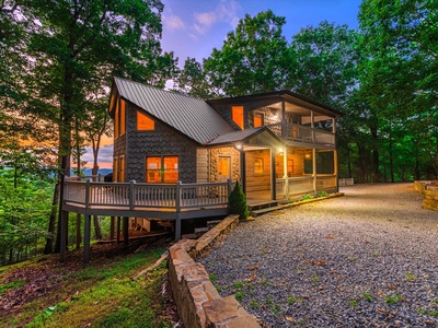 Aska Bliss- Evening views of the cabin featuring the driveway access and cabin lights