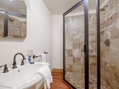 Gleesome Inn- Guest house bathroom with a walk in shower and pedestal sink