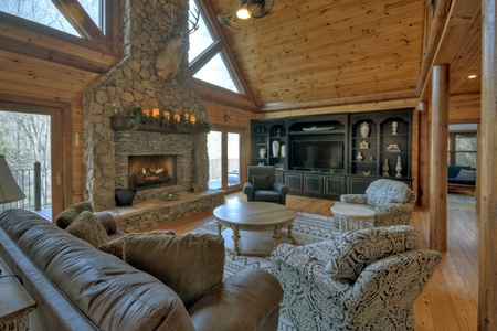 River Lodge- Living room area with large entertainment center and TV