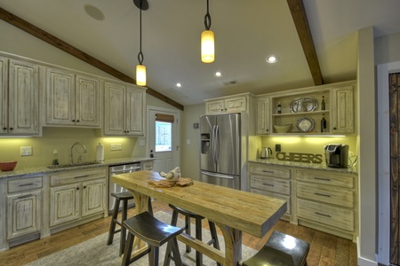 Main Street Cottage- Kitchen space with an island & stool seating