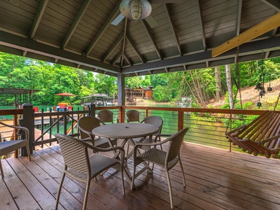 Gleesome Inn- Covered table and chair seating by the lake