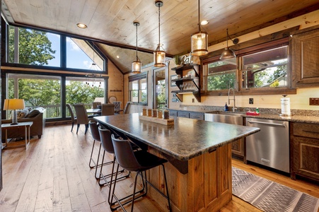 Mountain Echoes- Kitchen area with an island, stools and mountain views