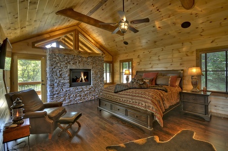 The Vue Over Blue Ridge- Master bedroom with a fireplace and lounge seating