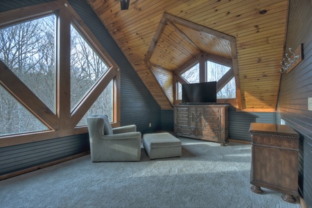 River Lodge- Upper level guest bedroom with a private TV area
