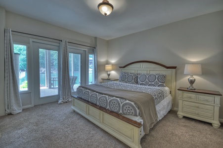 Jump Right In- Lower level bedroom with a view of the lake and patio access
