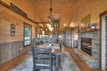 A Perfect Day- Dining room with a fireplace and kitchen view