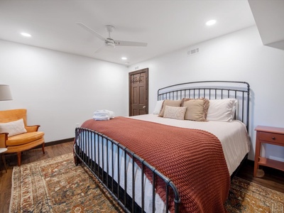 Gleesome Inn- Lower level bedroom with seating and dresser furniture