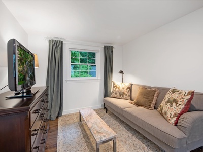 Gleesome Inn- Upper level bedroom seating area with a dresser and TV