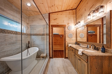 Feather & Fawn Lodge- Master bathroom with a closet double vanity sink and shower