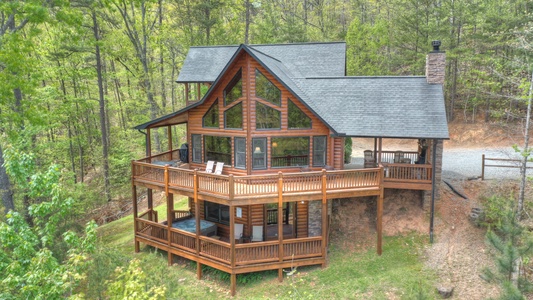 Aska Lodge- Exterior aerial view of the deck and floor to ceiling windows of the cabin