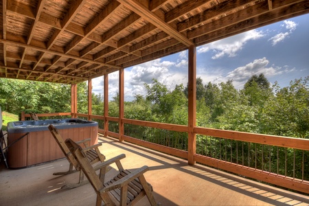 Above Ravens Ridge- Lower level patio with a hot tub