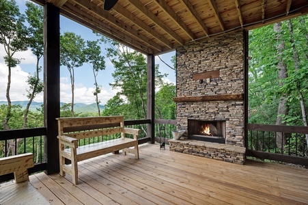 Feather & Fawn Lodge- Upper deck fireplace with a TV and outdoor seating