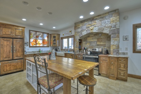 Family Farmhouse- Kitchen area with an island and stool seating