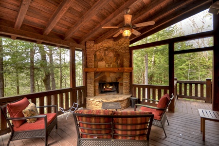 Reel Creek Lodge- Covered outdoor stone fireplace with outdoor plush seating