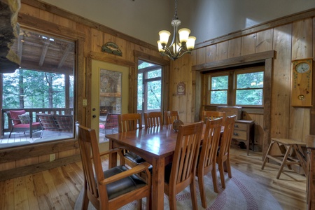Reel Creek Lodge- Dining room area with table and chair seating and deck access