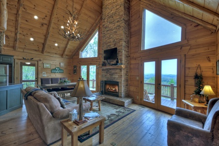 View From The Top- Living area with vaulted ceilings a fireplace and TV