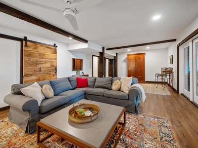 Gleesome Inn- Lower level living room area perspective view of the couch and seating area