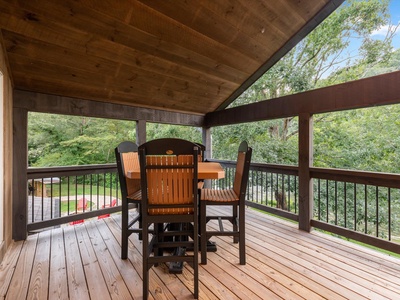The River House- Upper level deck seating with forest views
