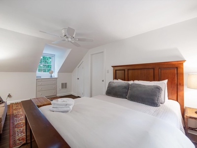 Gleesome Inn- Upper level bedroom with a dresser and window view