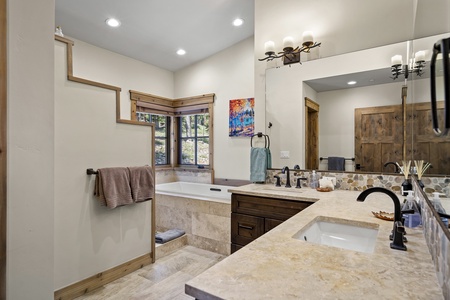 a spacious four-piece ensuite with a tub and shower combo, and a large vanity