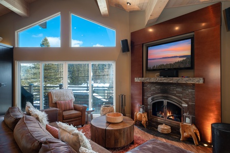 Living room with fireplace and wall mounted tv: Eagle's Nest Lodge