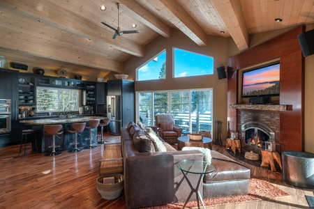 Living room with fireplace and nearby kitchen: Eagle's Nest Lodge