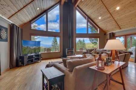 Living room with nearby Tv and large windows: Falcon's Eye View Retreat