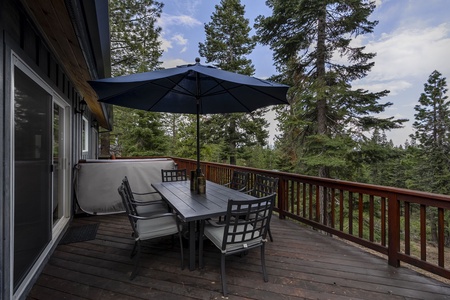 Main Floor: large patio with a hot tub with seating area