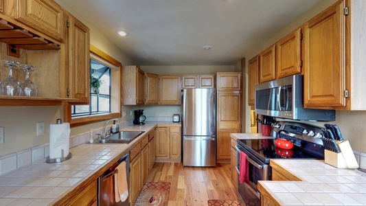 Gorgeous Kitchen with Cabinet Space and Stainless Steel Appliances: Wolfgang Vacation Cabin