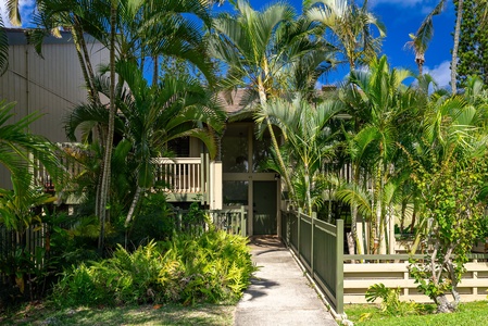 This tropical retreat sits nestled among lush palms and vibrant greenery, offering a serene island atmosphere from the moment you arrive at the welcoming entrance.