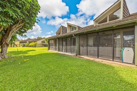 Modern vacation rental with screened lanai and spacious lawn area set in peaceful residential community.