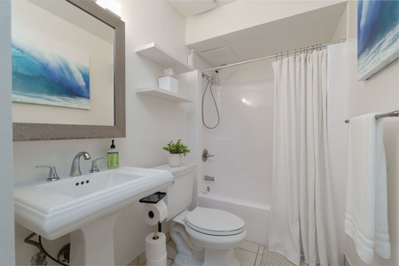 Step into your private retreat—a bright, spotlessly clean bathroom where coastal hues and thoughtful touches invite you to unwind after your day of adventure.