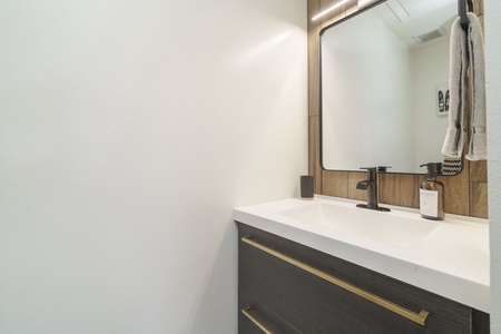 Step into your modern bathroom sanctuary with sleek fixtures, warm wood accents, and thoughtful amenities ready for your stay.