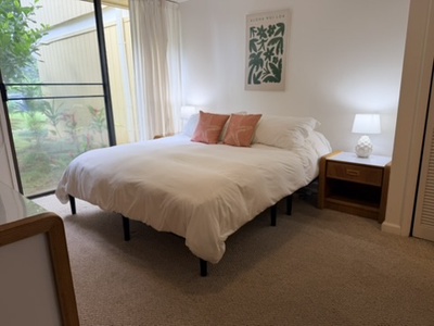 Step into your serene bedroom retreat, where natural light pours through floor-to-ceiling windows and a plush bed awaits your arrival after a day of adventure.