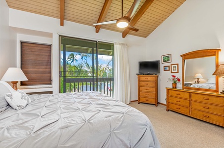 Wake up to tropical paradise through your private balcony doors, with warm wood beams overhead and island-style furnishings creating your perfect retreat.