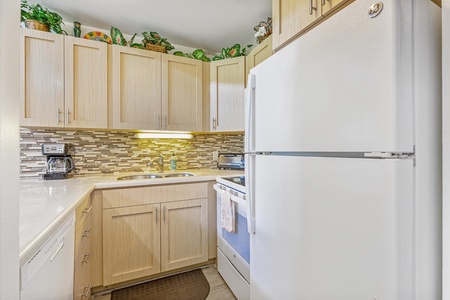 Whip up your favorite meals in this bright, well-equipped kitchen featuring modern appliances and beautiful mosaic backsplash details.