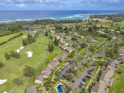 Stunning aerial view of the resort property nestled between championship golf course and pristine coastline with tropical landscaping throughout.