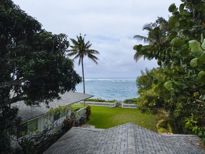 Tropical oceanfront property with lush palms and pristine waters just steps from the manicured lawn.