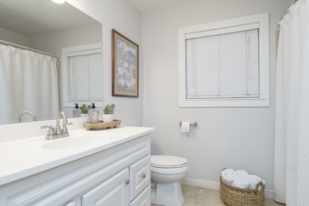 Step into your serene bathroom sanctuary with crisp white vanity, soft towels, and thoughtful touches that make freshening up feel like a spa retreat.