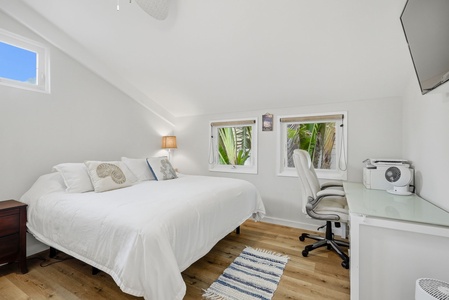 Unwind in your bright, airy bedroom with plush bedding, tropical garden views, and a dedicated workspace—perfect for rest or remote work.