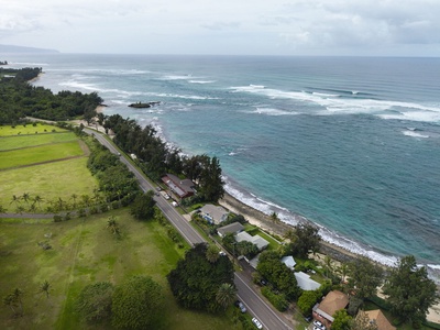 Stunning coastal location with crystal-clear turquoise waters and pristine shoreline. Properties nestled between lush green fields and the ocean.