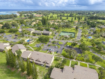 Aerial view of tropical resort property surrounded by lush golf courses, palm trees, and oceanfront location.