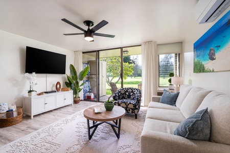 Sink into this inviting living room where sunlight streams through glass doors opening onto your private outdoor space. Stylish furnishings and cheerful touches create a welcoming retreat for unwinding after your adventures.
