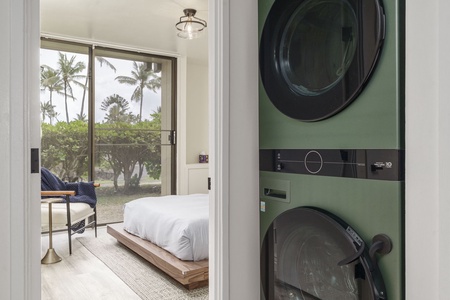 Your in-unit laundry setup makes extended stays effortless, while tropical palms frame your bedroom view.