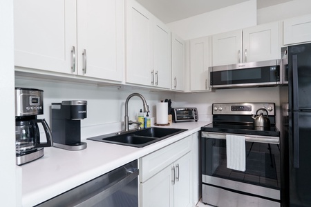 Your fully equipped kitchen awaits with modern appliances, sleek countertops, and everything you need to brew morning coffee or prepare a delicious meal during your stay.