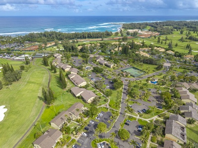 Tropical paradise resort sprawls across lush green fairways with pristine ocean coastline and championship golf course nearby.
